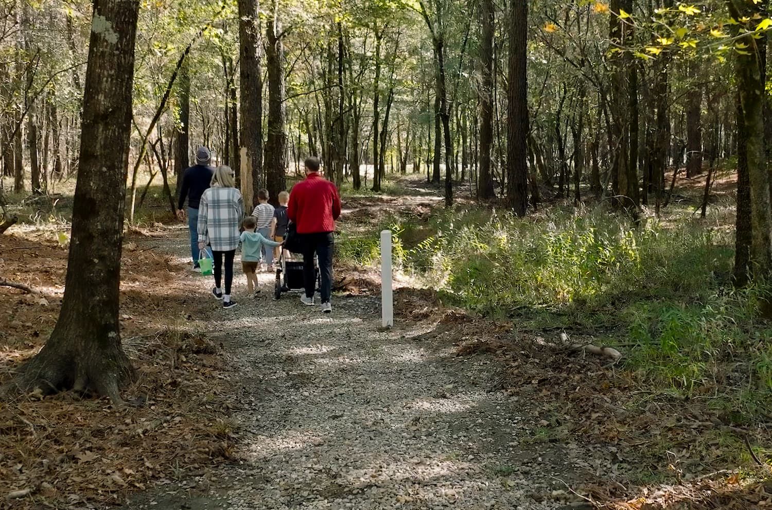 A family walking through trails in the wilderness.