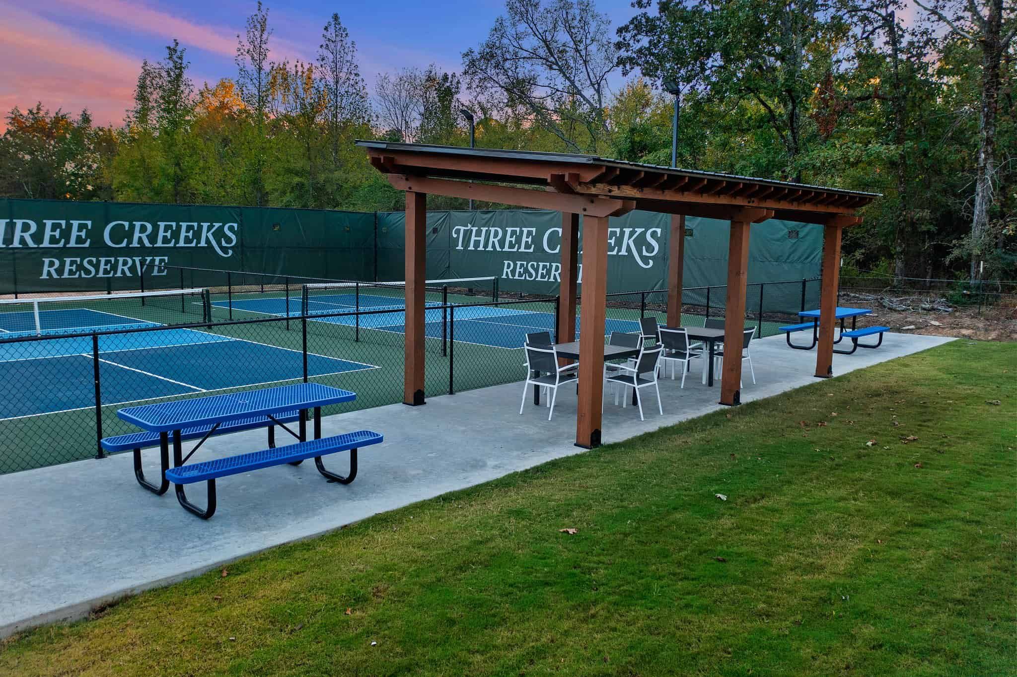 Picnic table area next to courts.