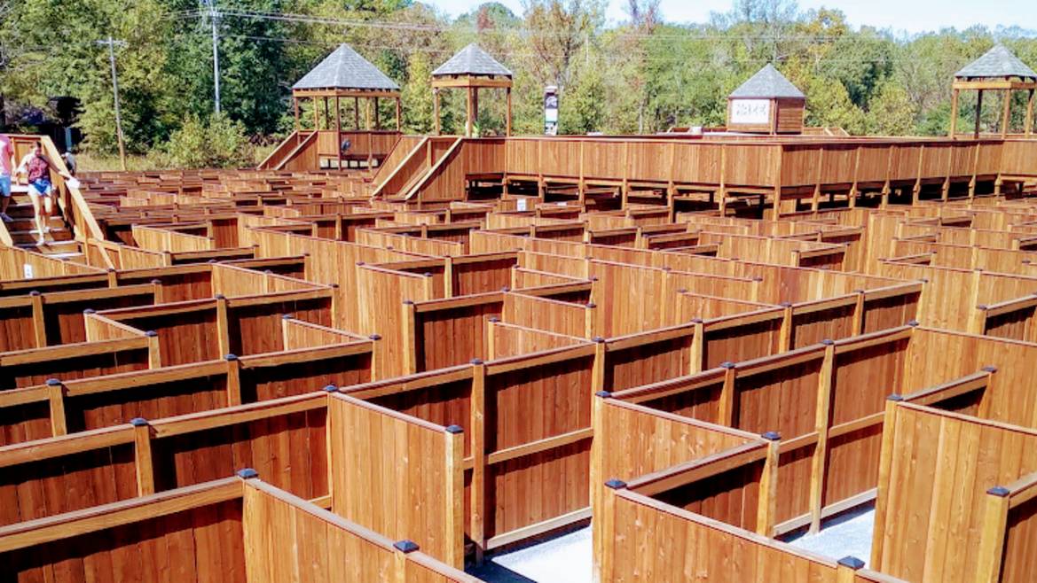 Aerial view of The Maze of Hochatown wooden maze attraction with families exploring near Broken Bow Oklahoma