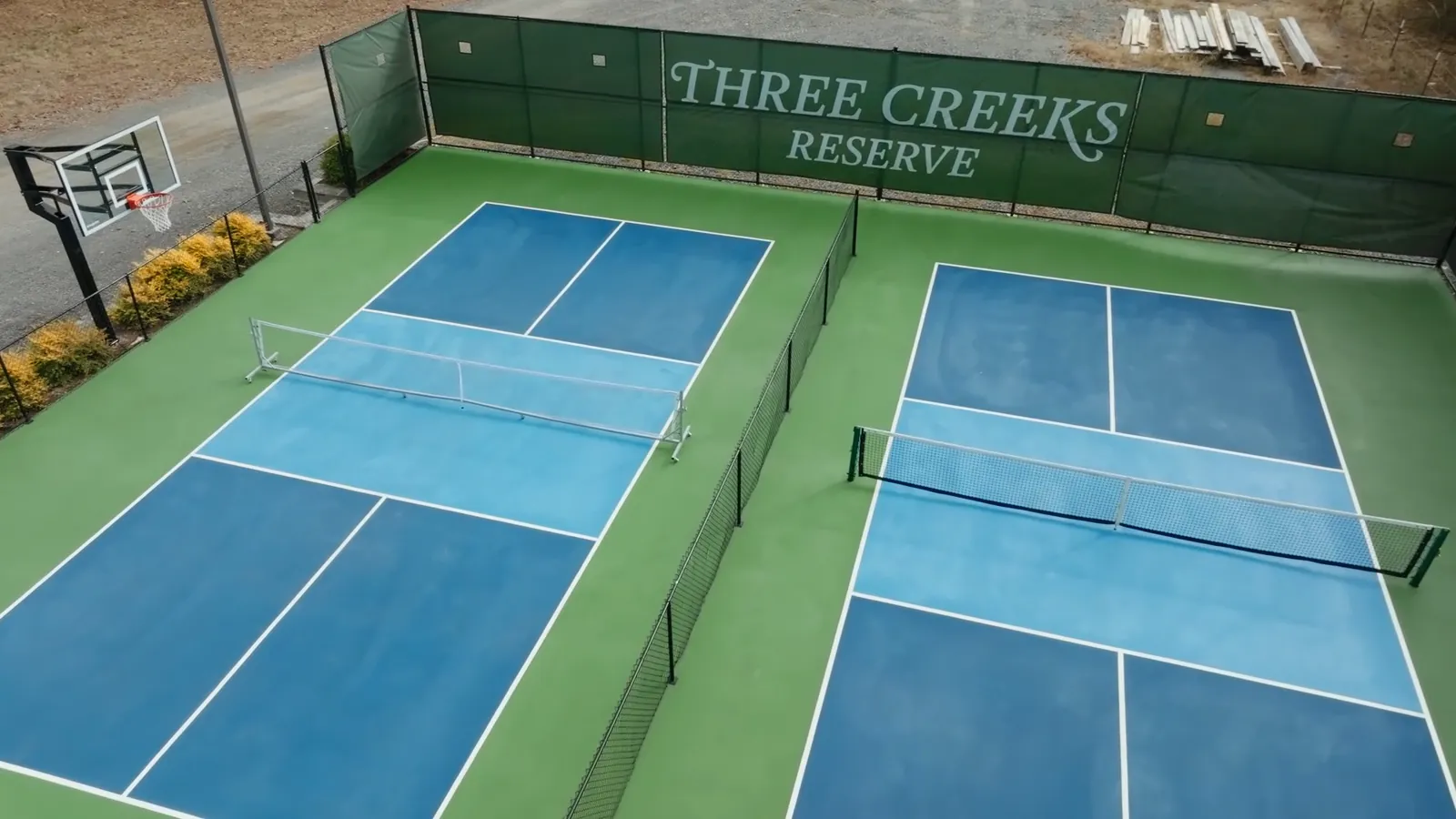 The Three Creeks Reserve pickleball and basketball courts from directly above