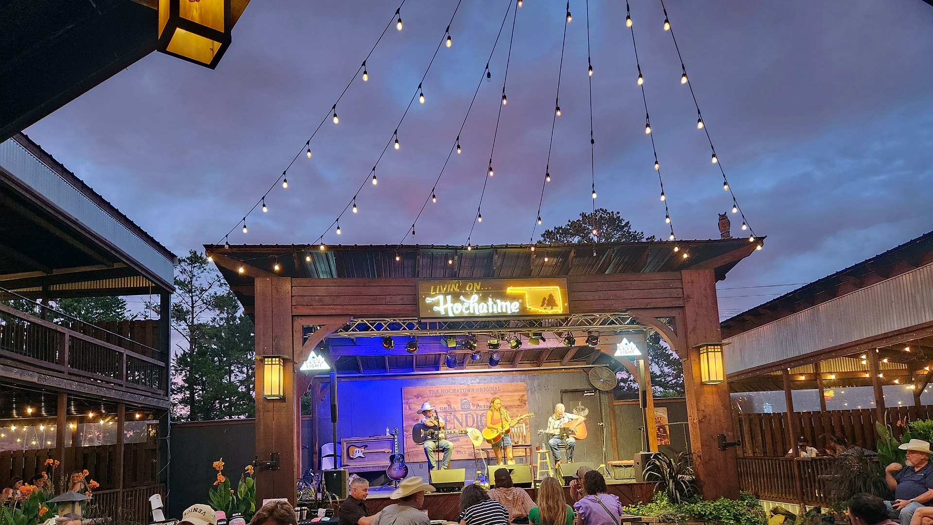 Live music on the courtyard stage under string lights at Abendigo's Grill & Patio in Hochatown