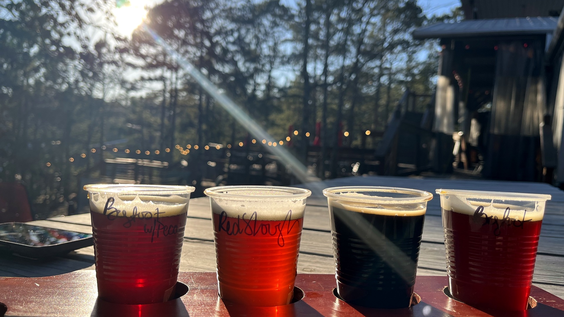 A beer flight in the afternoon sun on the deck at Beavers Bend Brewery