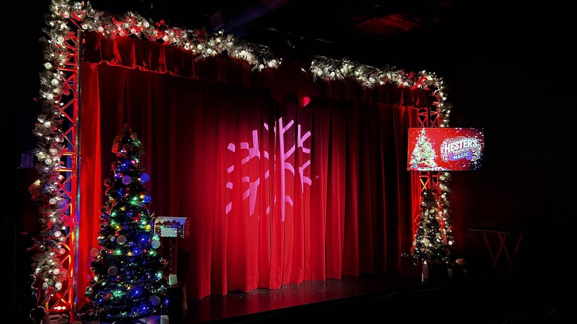 Hester's Theatre of Magic stage decorated with Christmas trees and lights