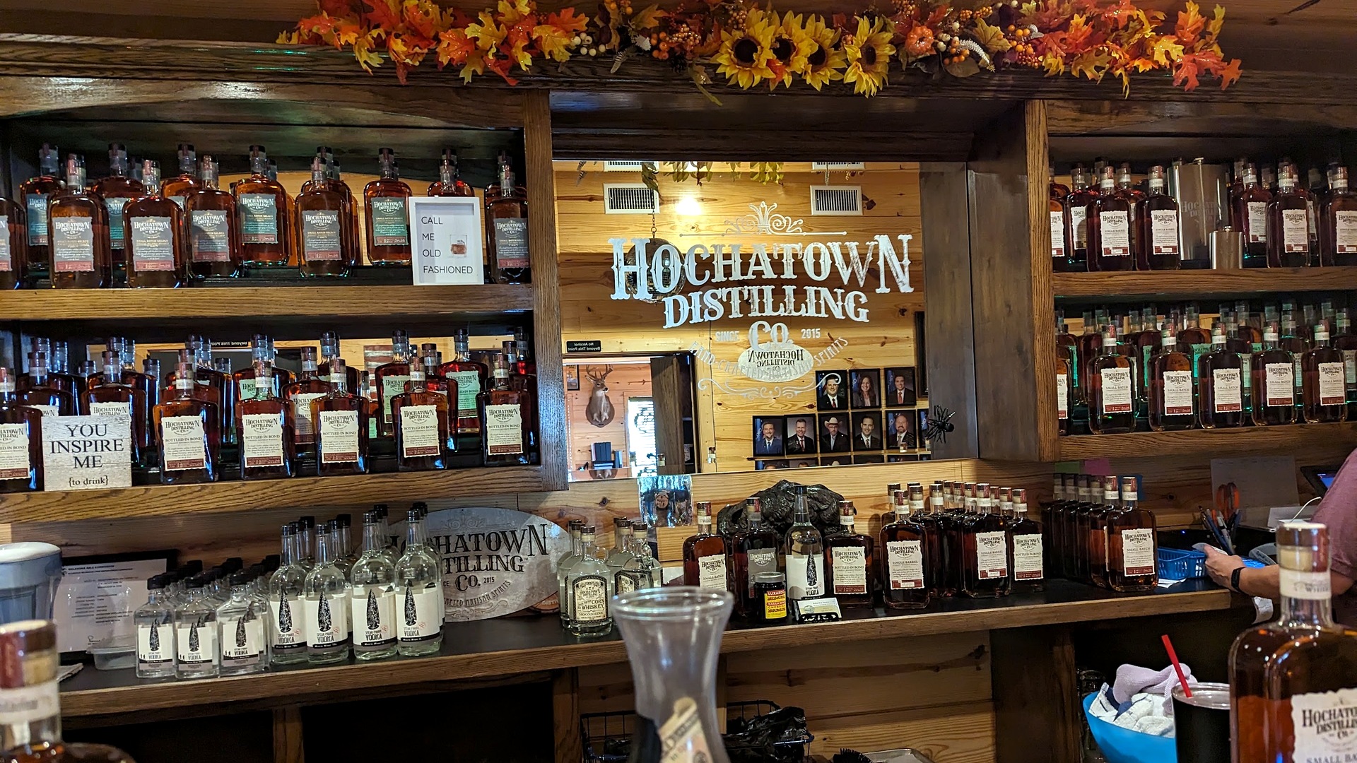 Tasting room shelves decorated for fall at Hochatown Distilling Company in Broken Bow