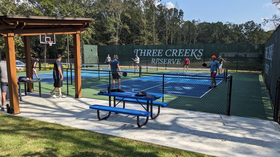 Guests playing on the pickleball courts at Three Creeks Reserve